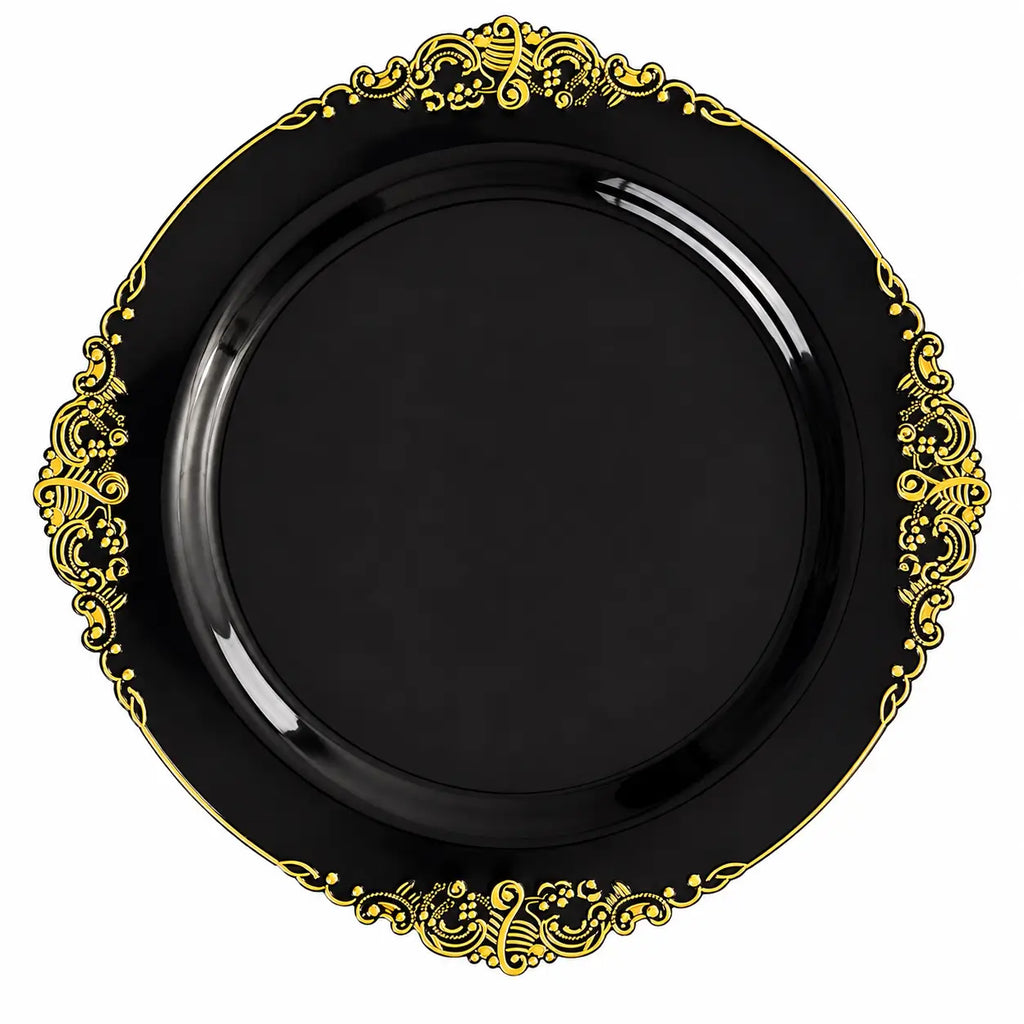 Black decorative plate with intricate gold ornate pattern around the rim, isolated on white background