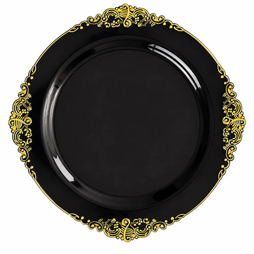 Black decorative plate with intricate gold ornate pattern around the rim, isolated on white background